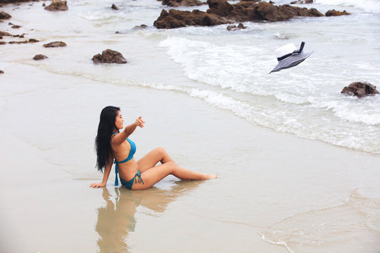 tourist wearing bikini throw  sunhat out before go to swin
