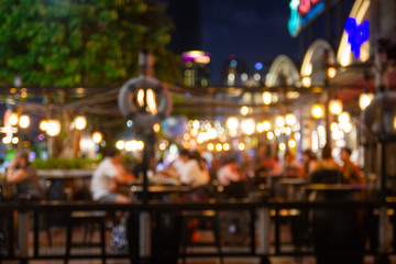 abstract blur image Lots of people enjoy the fun of night festival in a restaurant and The atmosphere is happy and relaxing.