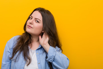 Young curvy plus size woman trying to listening a gossip.