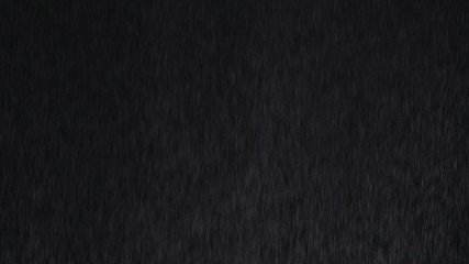 Fototapeta na wymiar 4k Heavy angled rain falling in front of the camera against black screen. Raindrops splashing. Rain closeup vfx insert. Practical seamlessly loopable footage. Heavy rainstorm hitting black surface.