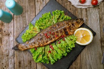 Fried sea bass on board