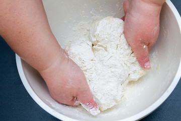 Mixing in a bowl of dough for the preparation of cottage cheese cookies
