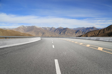 Empty highways and distant mountains