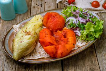 grilled vegetables on a plate on wooden background