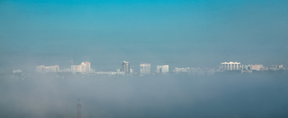 City in fog, as if floating in the clouds.