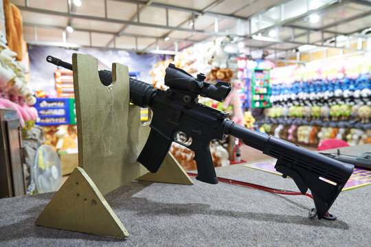 black rifle for shooting games on targets in the shooting range in an amusement park. Close-up