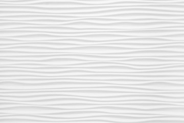 Fototapeta na wymiar Beautiful and voluminous white wall surface in the form of waves. Gypsum panels for finishing walls in the form of waves