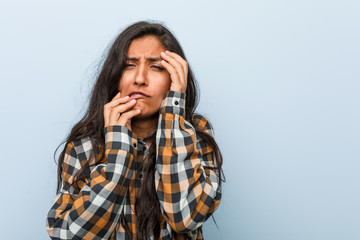 Young cool indian woman whining and crying disconsolately.