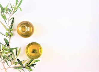 olive oil with a branch of green olives on white background