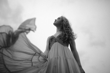 Fototapeta na wymiar fashionable woman in the wind 
