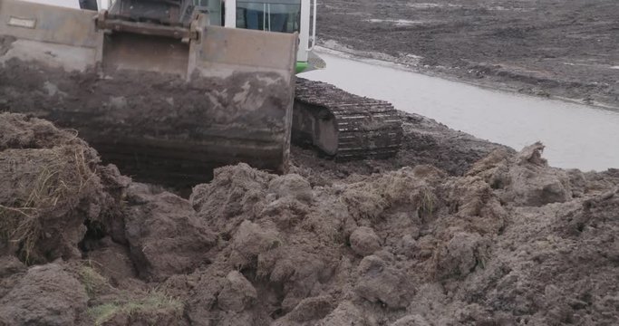 close up bucket excavator egalizing dirt