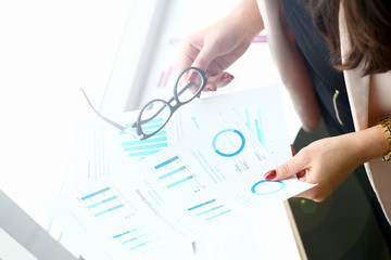 Businessman and businesswoman review graph financial statistics one on one office meeting. Infographic goals objectives planned growth assessment situation segmentation securities market reporting