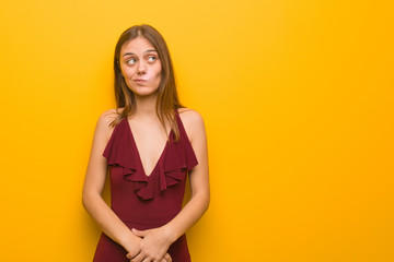 Obraz premium Young elegant woman wearing a dress thinking about an idea
