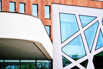 Abstract image of looking up at modern glass and concrete building. Architectural exterior detail of office building.