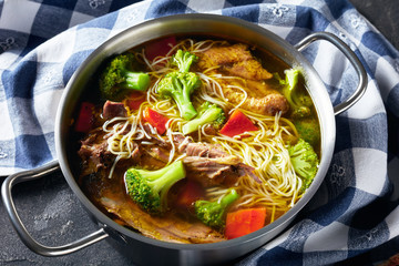 chicken noodle soup with broccoli, carrots, spices