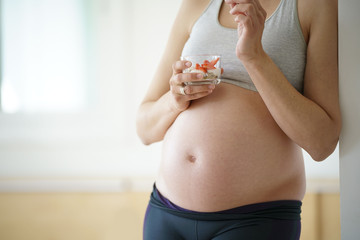Closeup of pregnant woman belly, strawberry crave