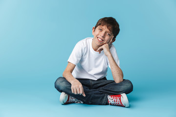 Image of european brunette boy 10-12y with freckles wearing white casual t-shirt smiling at camera...