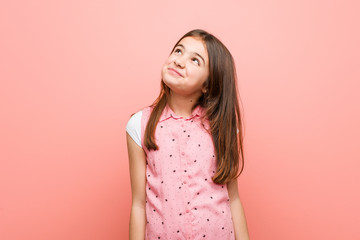 Cute little girl dreaming of achieving goals and purposes