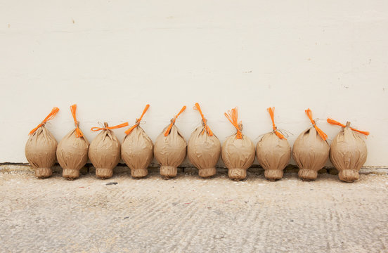 Firework powder bags in a row by a wall, Malta