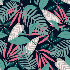 Seamless pattern with tropical plants on dark background. Vector design. Floral background.