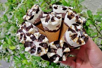 white ice cream with chocolate and nuts closeup