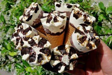 white ice cream with chocolate and nuts closeup