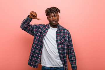 Young african black man showing a dislike gesture, thumbs down. Disagreement concept.