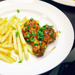 Chicken legs with french fries potatoes