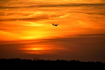 Fototapeta na wymiar Airplane flying at sunset over the river St. Augustine, Florida