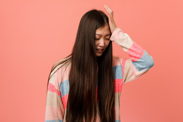 Young cool chinese woman forgetting something, slapping forehead with palm and closing eyes.