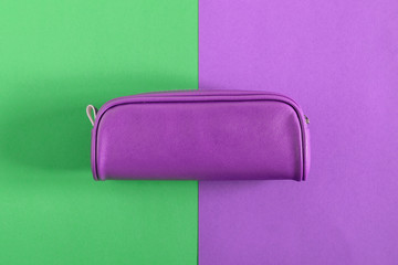 Back to school. Colorful minimal composition of school supplies on green and purple background. Flat lay, top view, copy space