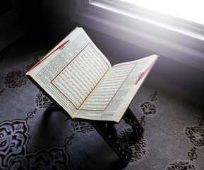 open quran in front of windows