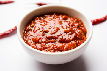 Schezwan Sauce / Szechuan chutney is an important ingredient in Chinese recipe. served in a bowl, isolated.  selective focus