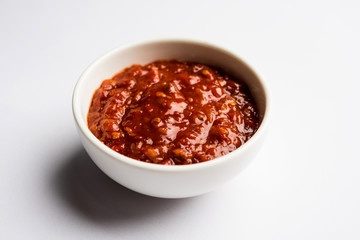 Schezwan Sauce / Szechuan chutney is an important ingredient in Chinese recipe. served in a bowl, isolated.  selective focus