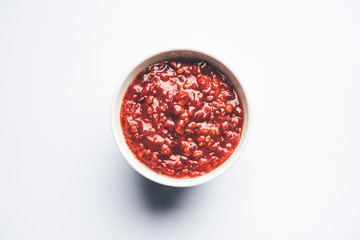 Schezwan Sauce / Szechuan chutney is an important ingredient in Chinese recipe. served in a bowl, isolated.  selective focus