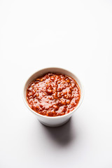 Schezwan Sauce / Szechuan chutney is an important ingredient in Chinese recipe. served in a bowl, isolated.  selective focus