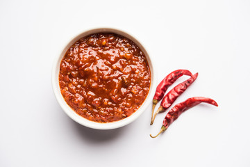Schezwan Sauce / Szechuan chutney is an important ingredient in Chinese recipe. served in a bowl, isolated.  selective focus