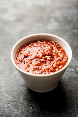 Schezwan Sauce / Szechuan chutney is an important ingredient in Chinese recipe. served in a bowl, isolated.  selective focus