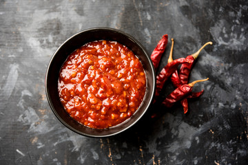 Schezwan Sauce / Szechuan chutney is an important ingredient in Chinese recipe. served in a bowl,...