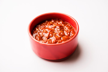 Schezwan Sauce / Szechuan chutney is an important ingredient in Chinese recipe. served in a bowl,...
