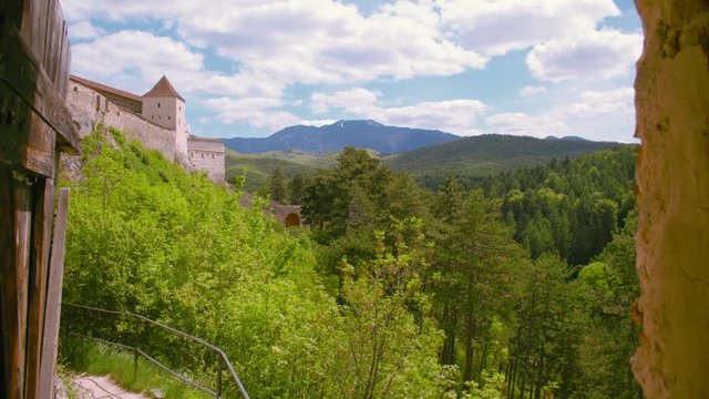 Sunshine valley with medieval castle in Transylvania