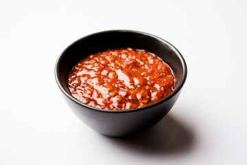Schezwan Sauce / Szechuan chutney is an important ingredient in Chinese recipe. served in a bowl, isolated.  selective focus