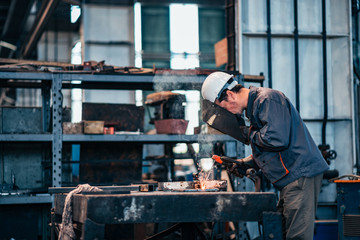 Worker welds at the factory.