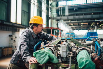 Mechanic wearing safety equipment working at factory.