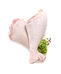 Raw turkey drumsticks and ingredients on white background, top view