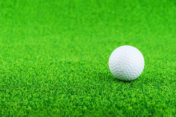 Golf ball put on the green grass