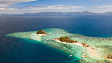 Fototapeta na wymiar Seascape bay with turquoise water and coral reef and beach. Tropical island with white beach. Bulog Dos, Philippines, Palawan aerial view
