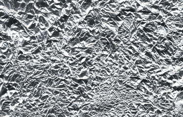  foil texture background. Thin sheet of silver leaf background with shiny uneven surface