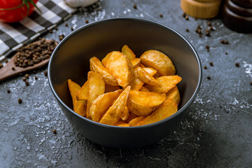 The potatoes wedges on the Black concrete