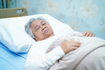 Asian senior or elderly old lady woman patient smile bright face with strong health while lying on...